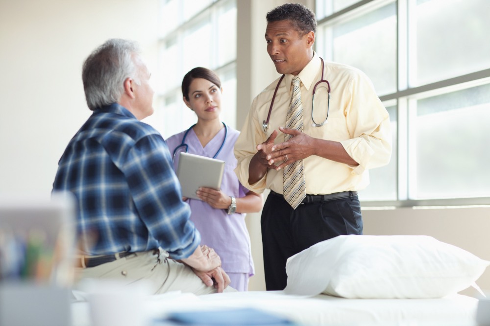 Doctors talking to senior patient